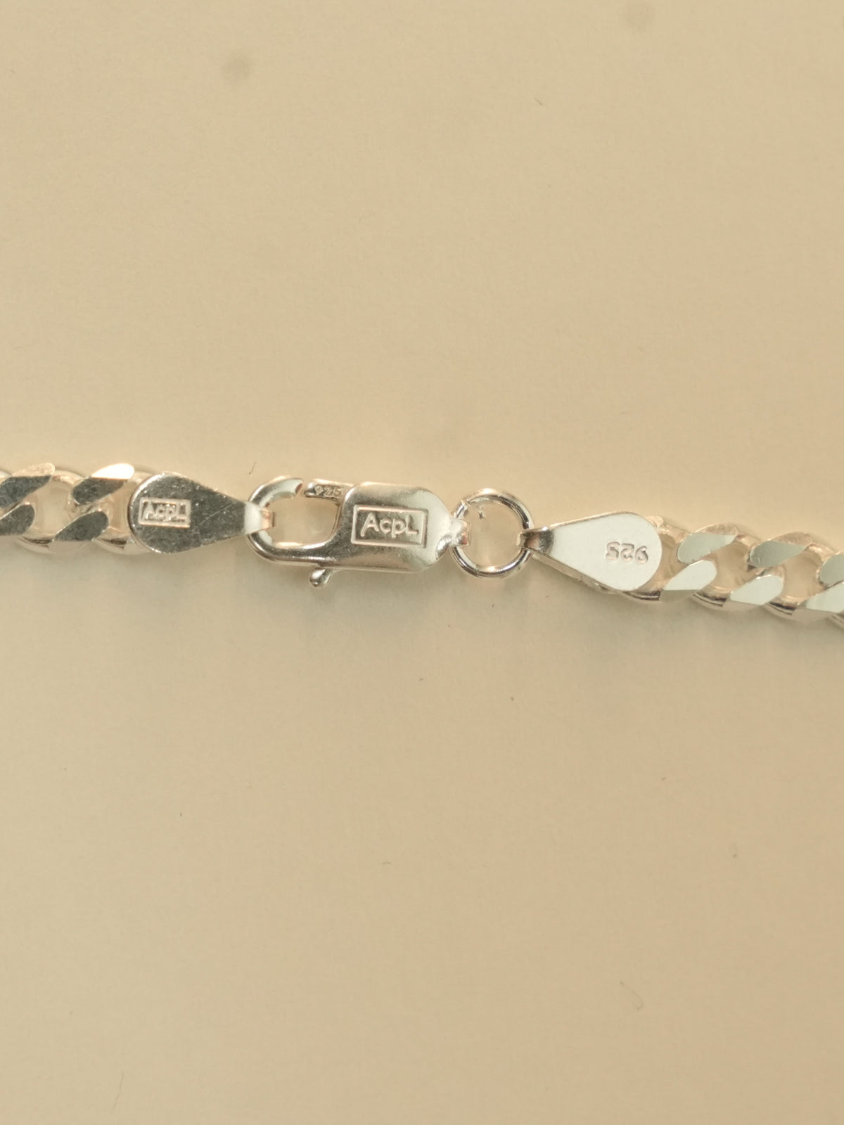 Close view of the lobster clasp and the two end tabs, one stamped 925.