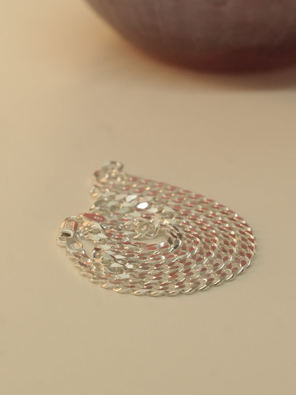 The curb chain coiled in a spiral, seen from a low angle.