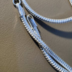 The lobster clasp and end tabs of the silver omega snake chain.
