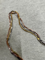 Close view of the strands of the sterling silver box chain necklace, showing the three finishes running side by side.