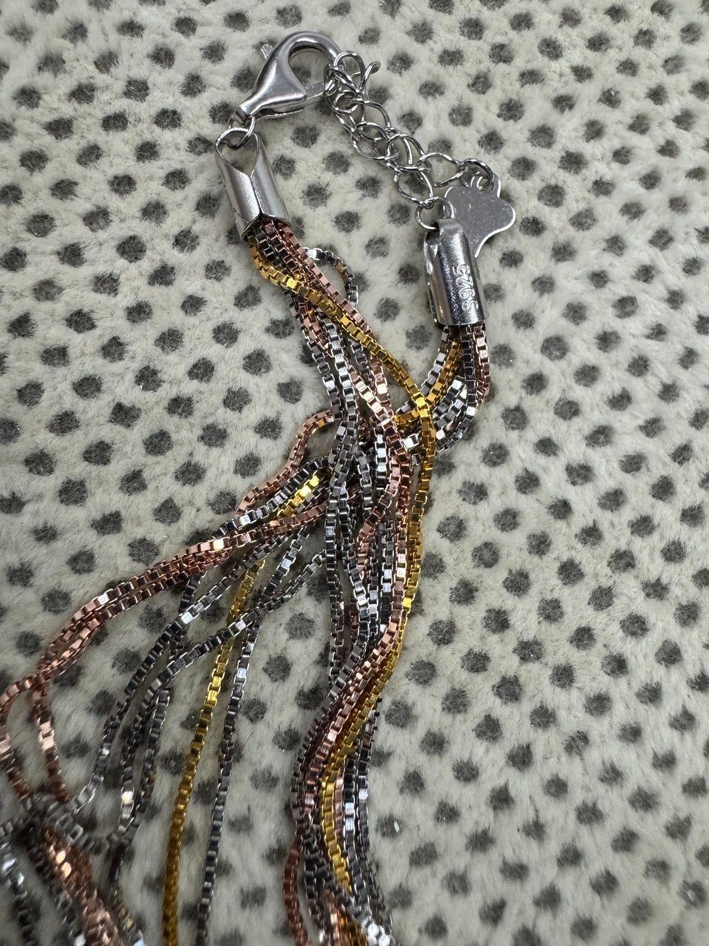 End cap, 925 stamp, lobster clasp and extender chain of the sterling silver box chain necklace.
