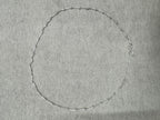 The 45 cm sterling silver box chain necklace laid out in a full circle on grey felt.