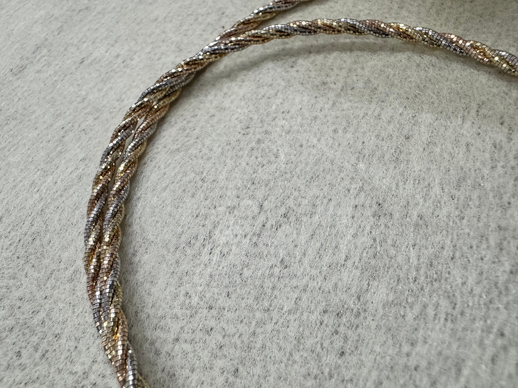 Close view of the twisted sterling silver rope chain, the three tones running along the length of the necklace.