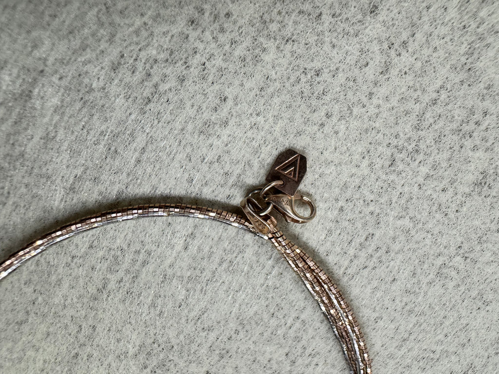Lobster clasp and Javeri House tag on the rose-tone sterling silver snake chain necklace.
