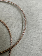 Close view of the round sterling silver snake chain, showing the rose-tone finish and the bright cut faces.