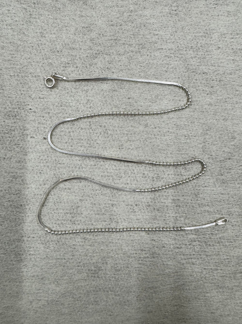 Full 45 cm length of the sterling silver chain necklace laid out on grey felt, showing snake sections alternating with runs of round beads and a spring ring clasp.