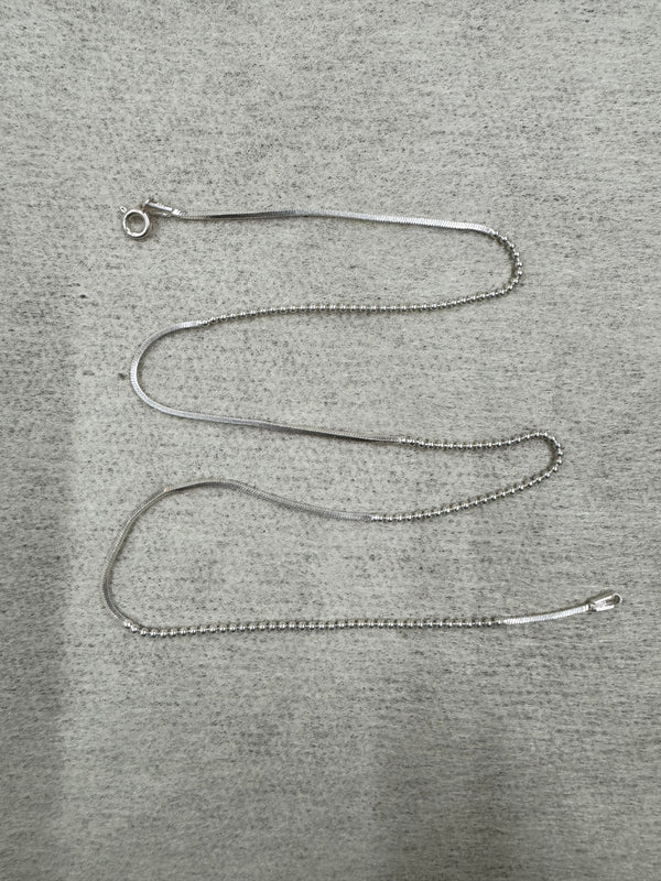 Full 45 cm length of the sterling silver chain necklace laid out on grey felt, showing snake sections alternating with runs of round beads and a spring ring clasp.