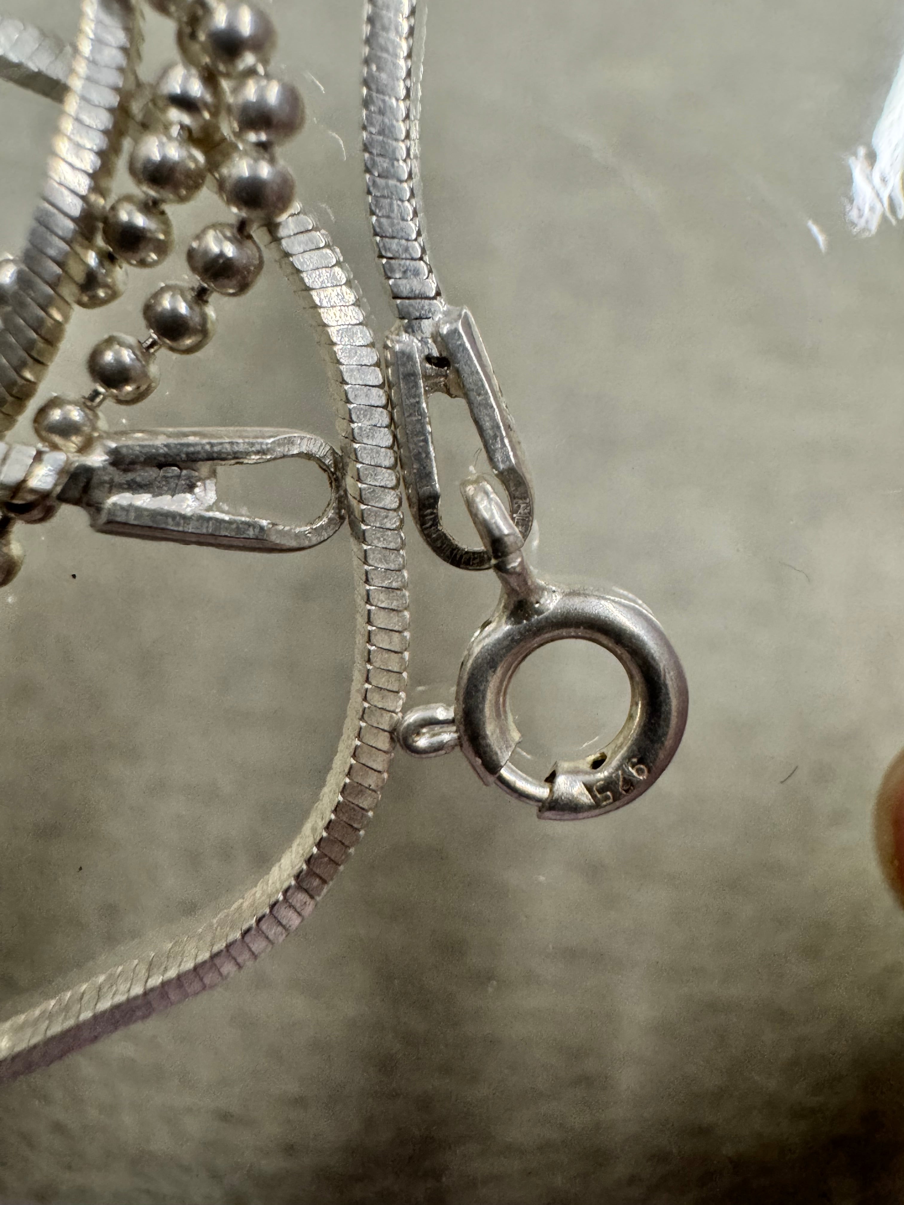 Spring ring clasp stamped 925 and the flat end tag on the sterling silver bead and snake chain necklace.