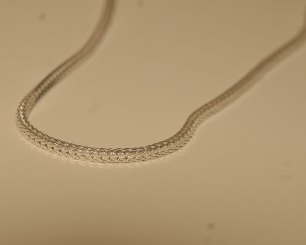 Close view of the foxtail weave, showing the chevron pattern along the chain.