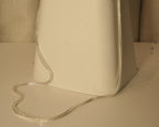 The silver foxtail chain draped over a white block, showing how it falls.