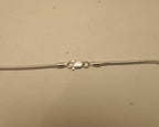 Close view of the lobster clasp on the silver snake chain, with the silver mark beside it.