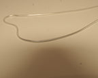 Close view of the silver snake chain, showing the smooth round surface with no visible links.