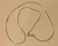 Slim sterling silver foxtail chain coiled on a pale surface with the clasp at the centre.