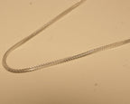 Close view of the foxtail weave, showing the chevron pattern along the chain.