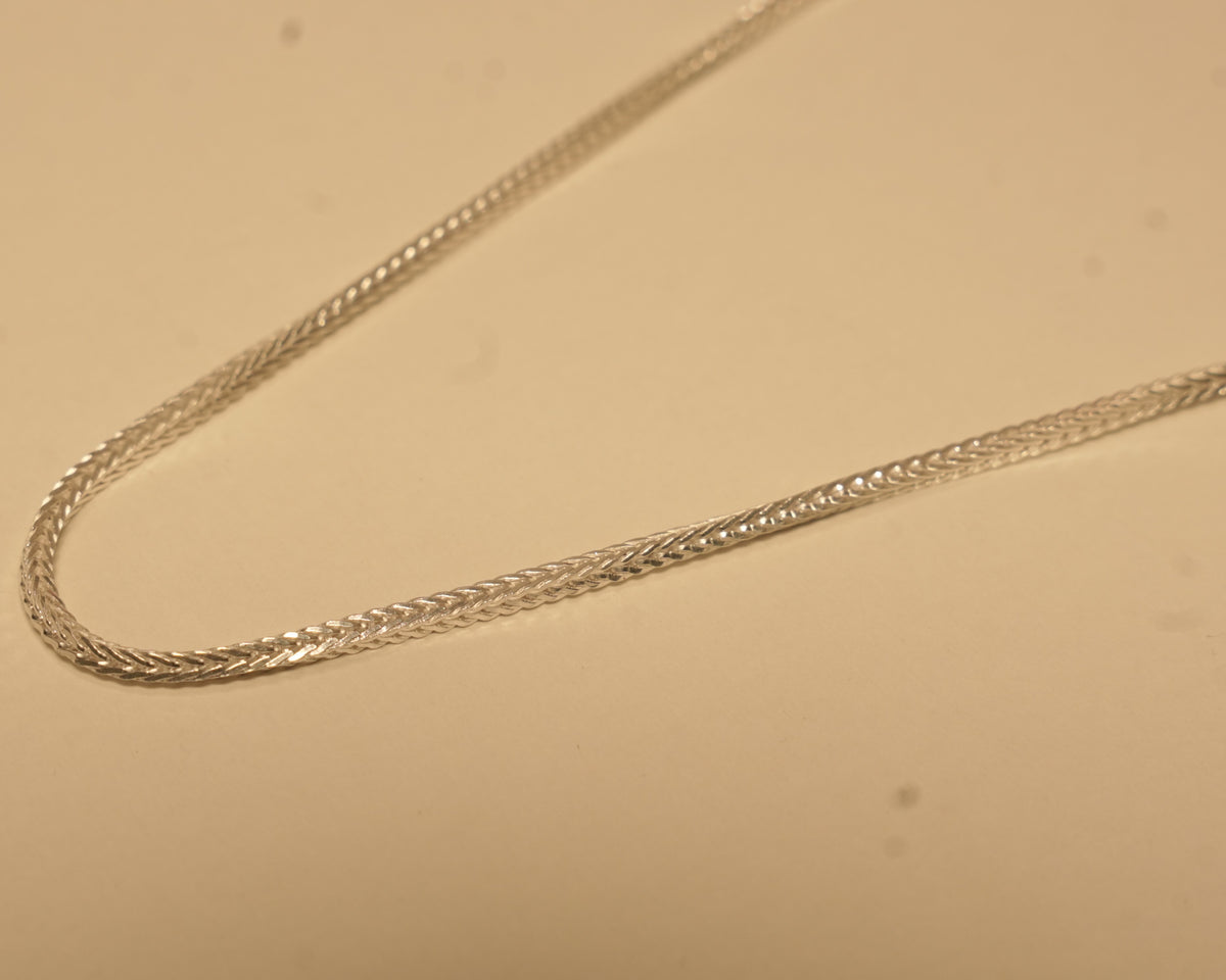 Close view of the foxtail weave, showing the chevron pattern along the chain.