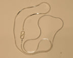 Sterling silver flat snake chain coiled on a pale surface with the S hook to one side.