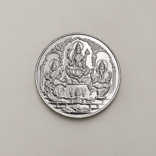 20 gram fine silver coin with Lakshmi, Ganesh and Saraswati under temple arches, on a beige surface.
