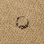 Single beaded Bali hoop in sterling silver showing the rope coil and scroll detailing around the centre bead.