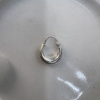 The small plain kundal hoop earring seen from a slight distance.