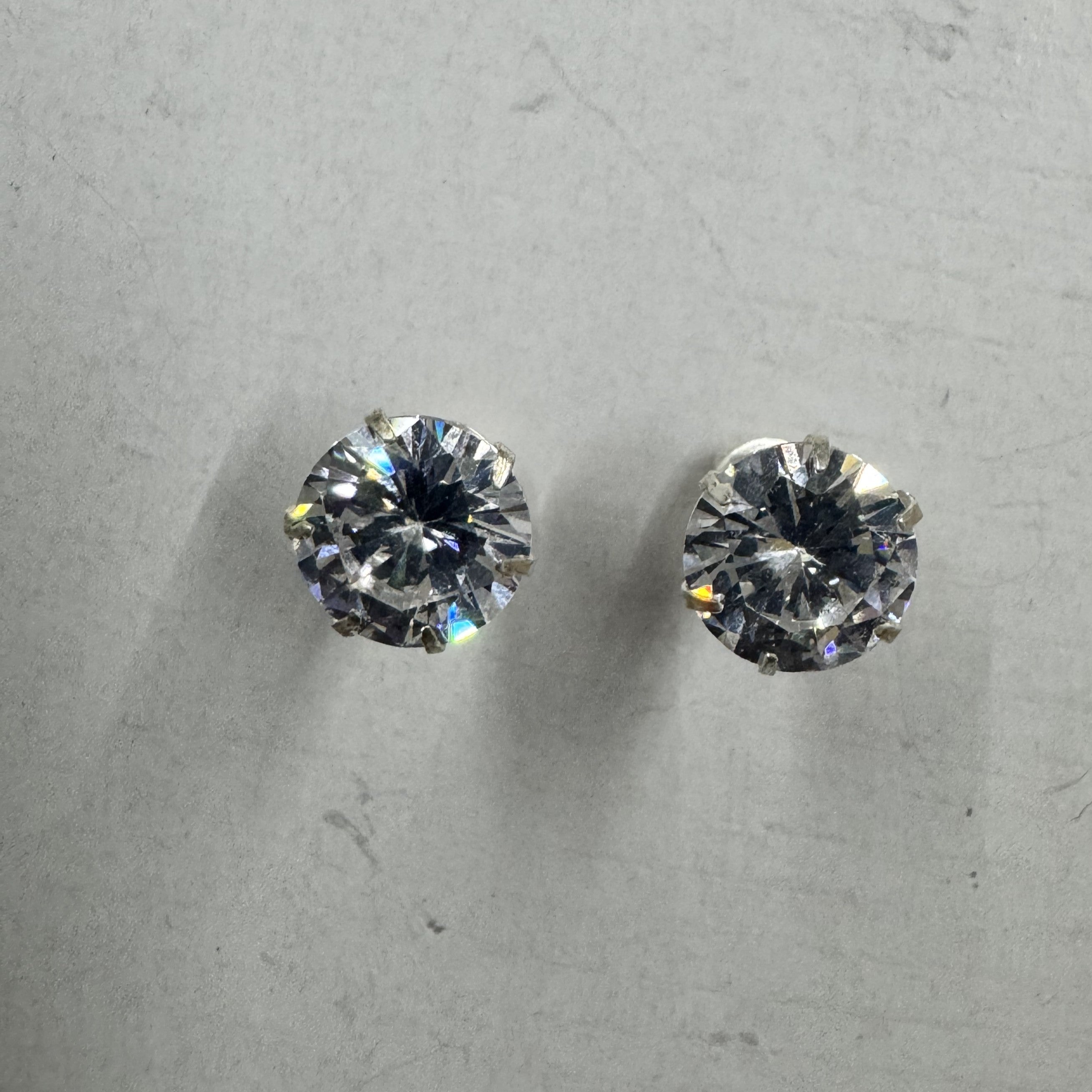 Both sterling silver cubic zirconia stud earrings face-on, showing the matched size and cut of the two stones.