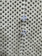 The two sterling silver studs set at an angle, showing the square cubic zirconia held at its corners by four claws.