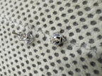 Reverse of the sterling silver cubic zirconia studs, showing the open four-claw basket, the threaded post and the screw back.