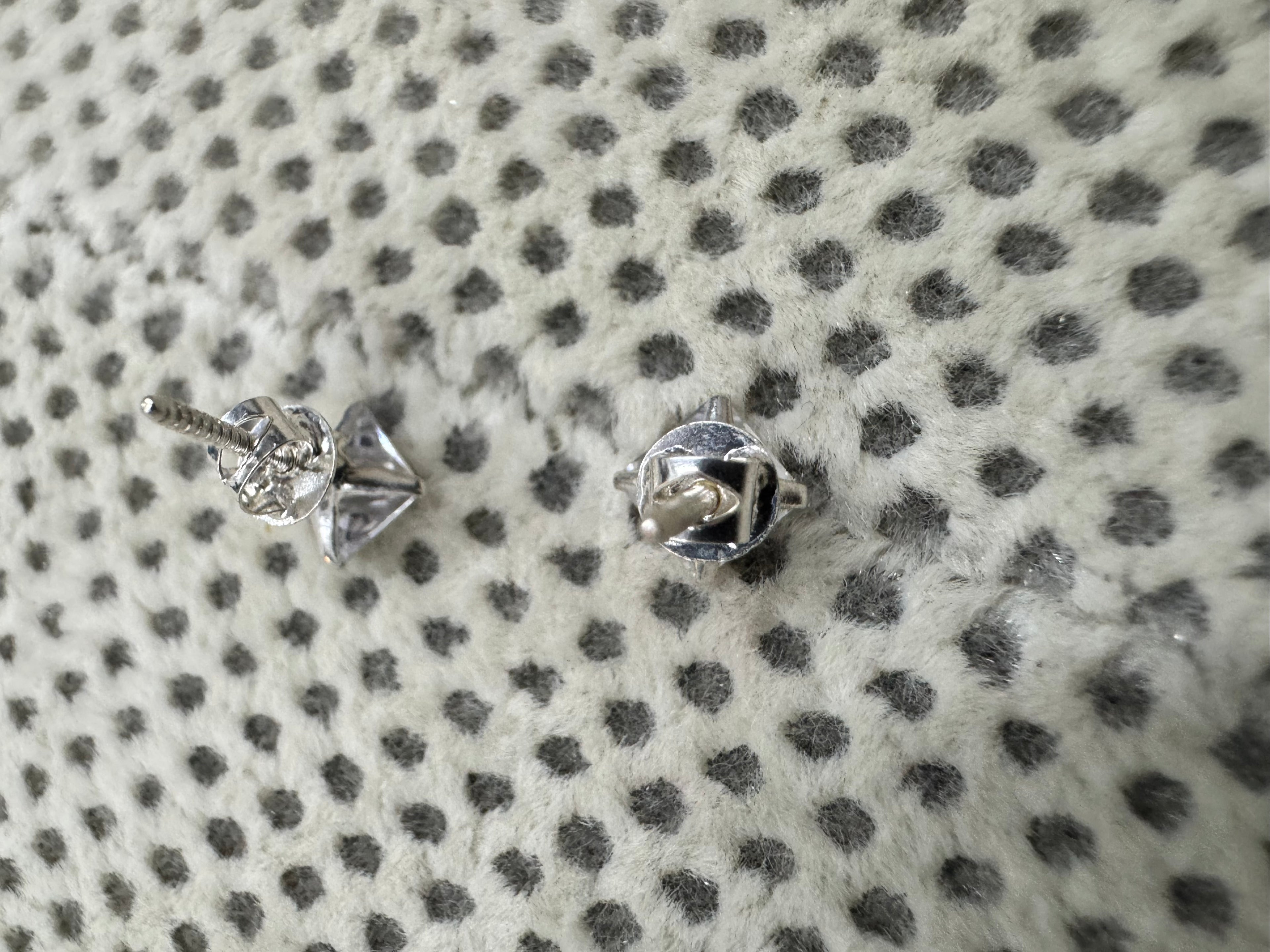 Reverse of the sterling silver cubic zirconia studs, showing the open four-claw basket, the threaded post and the screw back.