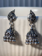 Oxidised sterling silver peacock stud jhumka with a teardrop cutout dome and bead fringe.