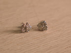 Close view of the butterfly studs, showing the pave set wings and polished outlines.