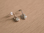 Close view of the heart padlock drops, showing the pave set bars and polished heart faces.