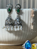 Pair of antique style sterling silver jhumkas with teardrop green glass stones and white bead fringes.