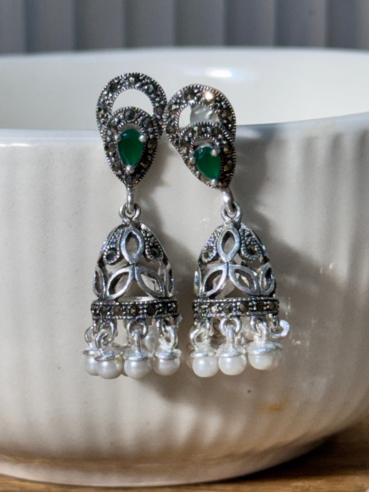 Angled view of the antique style jhumkas, showing the depth of the domes and the bead rows.