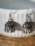 Pair of oxidised sterling silver dome jhumkis on french hooks with ghungroo bell fringes.