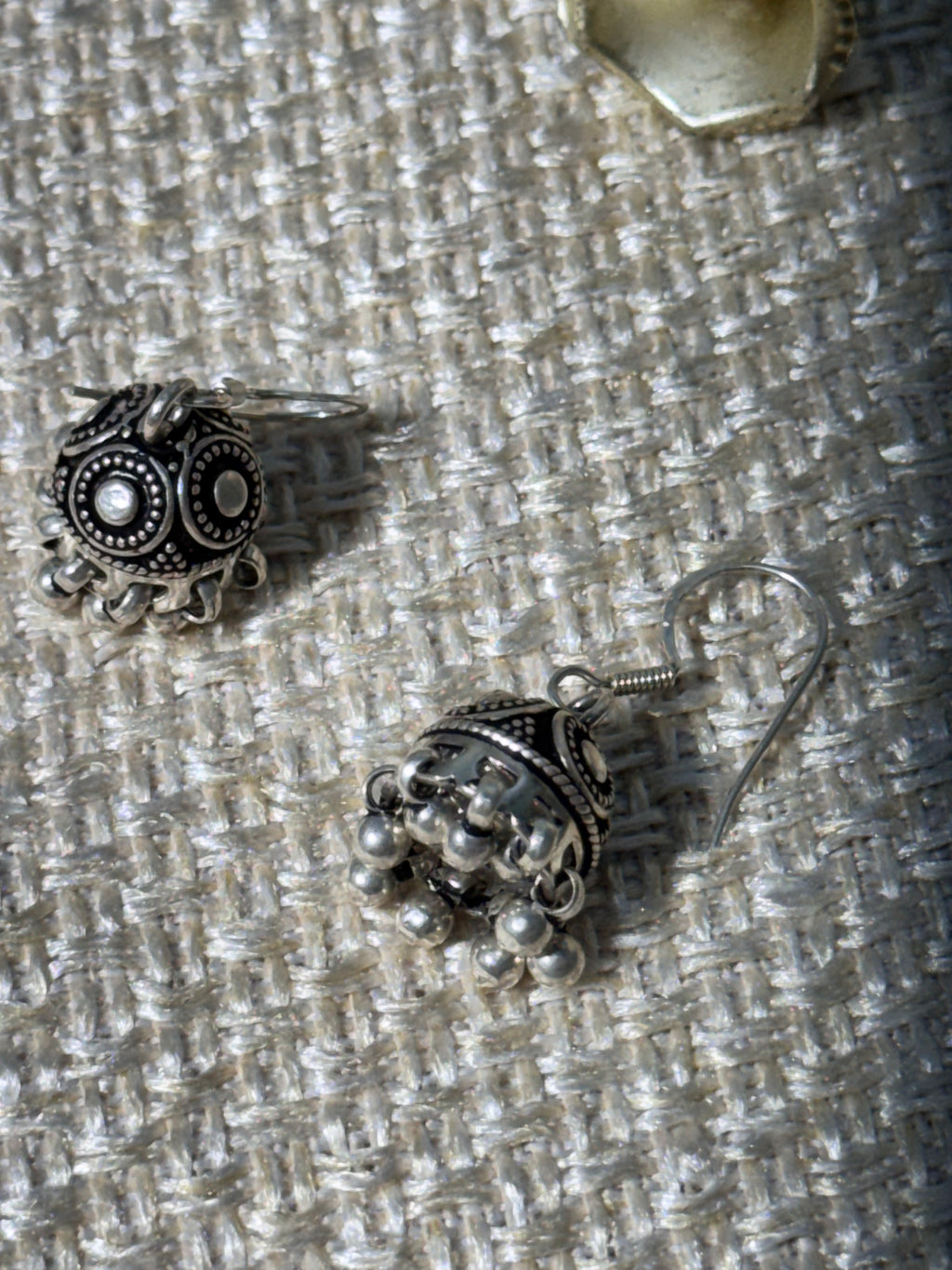 Close view of the ribbed oxidised jhumki dome and the row of ghungroo bells.