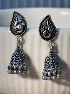 Pair of oxidised sterling silver paisley stud jhumkas with pierced cones and bead fringes.