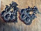 Both temple style statement earrings shown upright against a plain background.