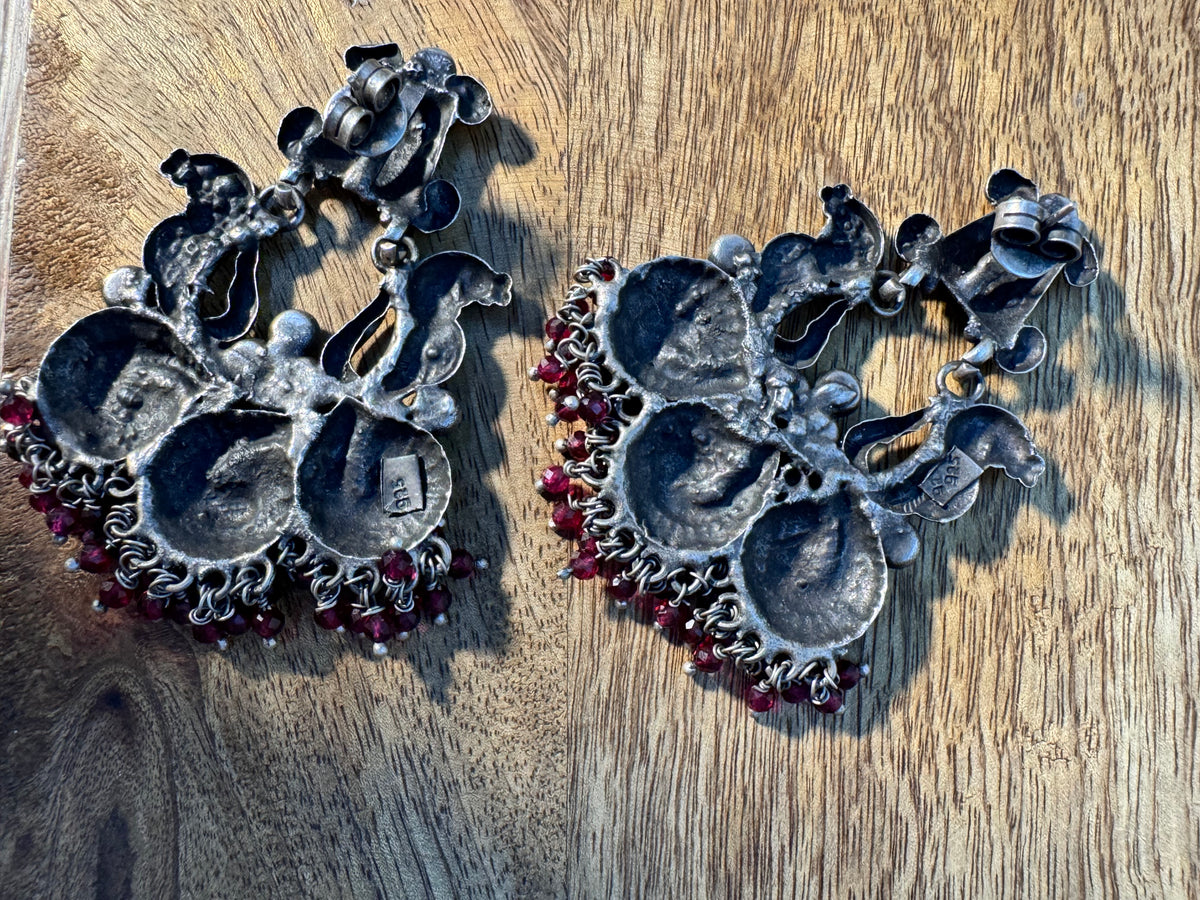 Both temple style statement earrings shown upright against a plain background.