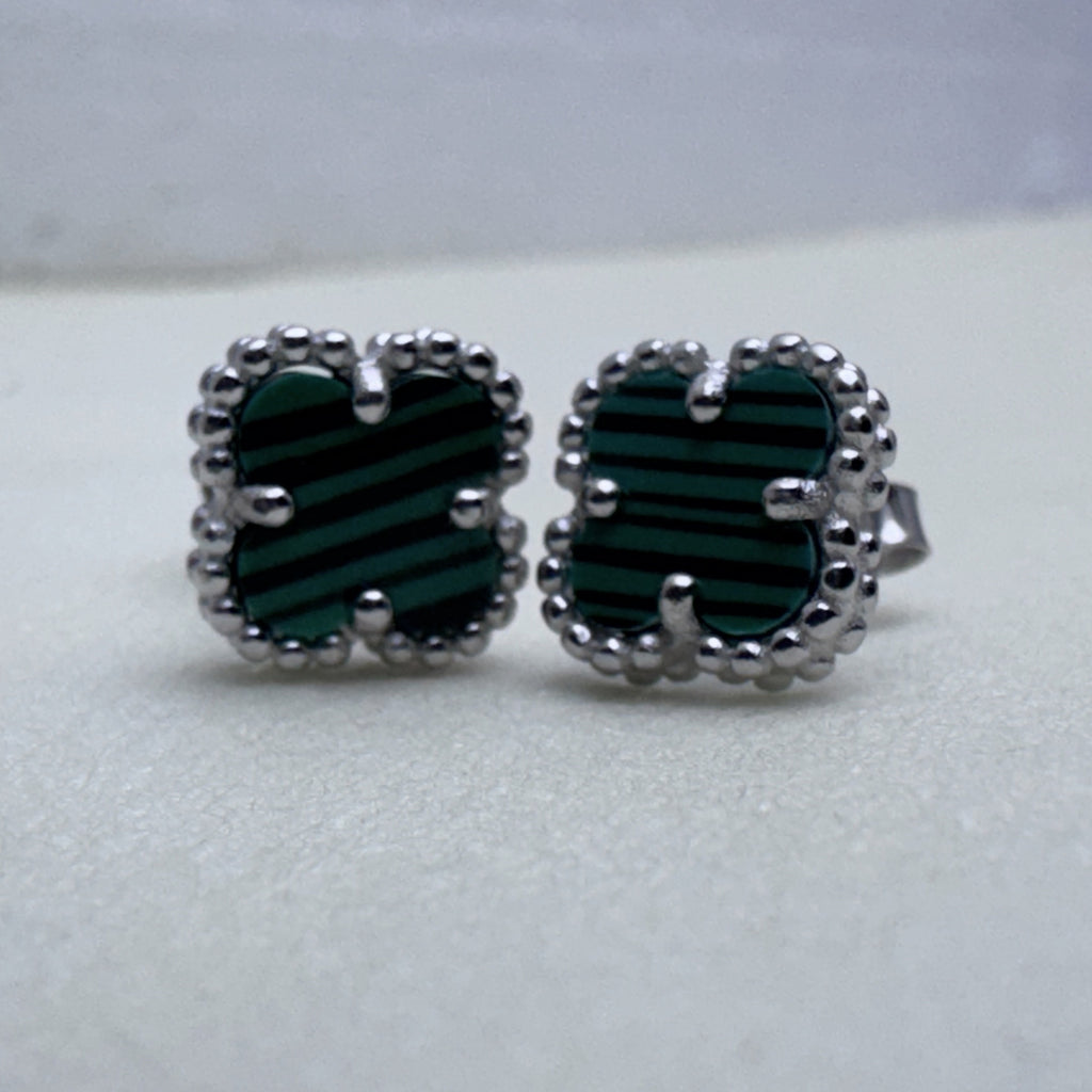 Close view of the green banded glass and the beaded edges of the two studs.