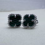 Close view of the green banded glass and the beaded edges of the two studs.