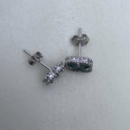 The clover studs seen from the side, showing the posts and push backs.
