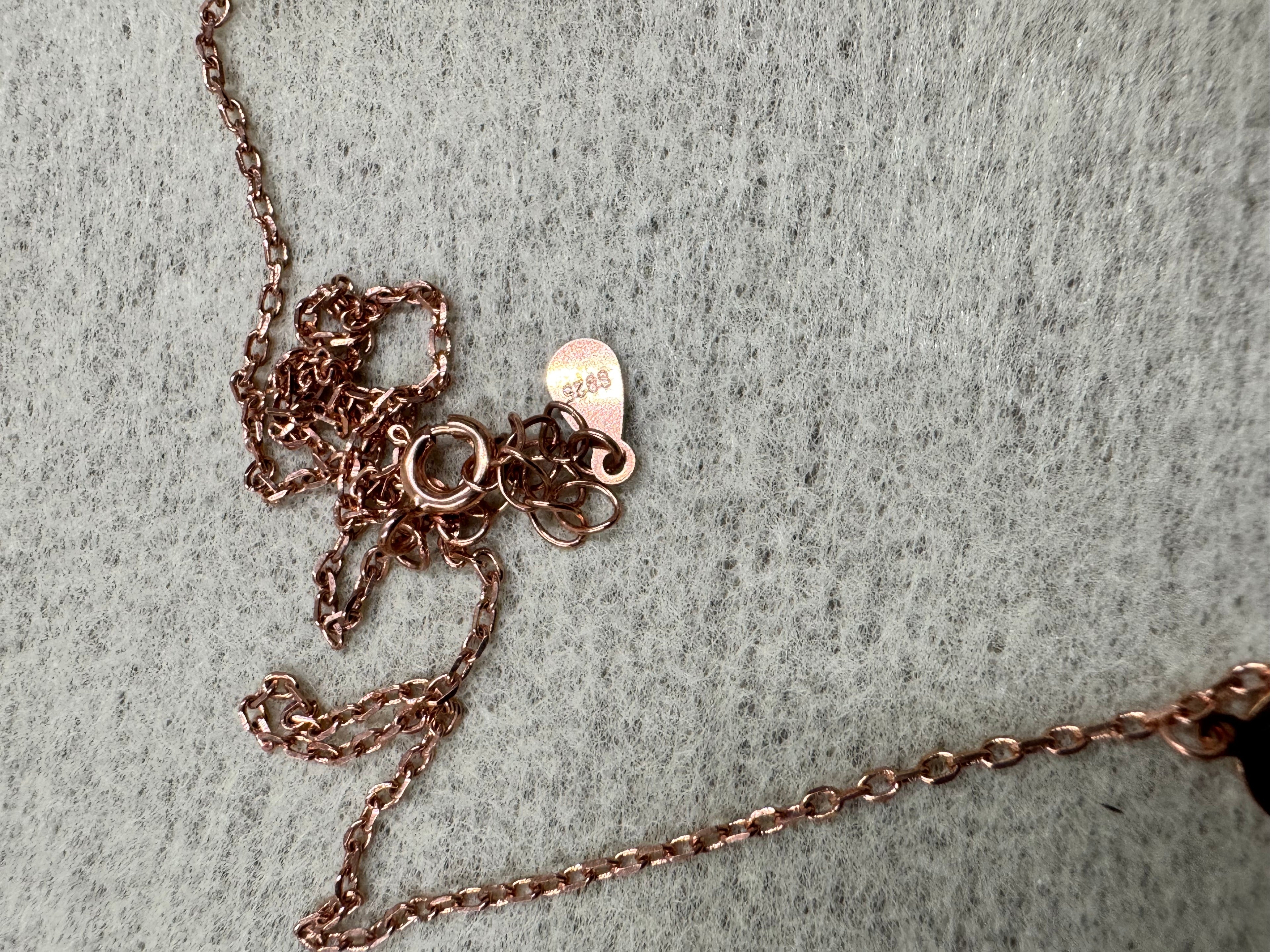Spring ring clasp, extender chain and the teardrop 925 tag on the rose-tone sterling silver necklace.