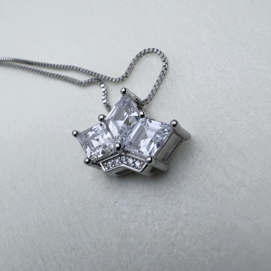 Sterling silver crown pendant necklace with three princess-cut American Diamonds, on a box chain.