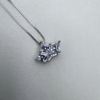 The crown pendant hanging from the box chain.