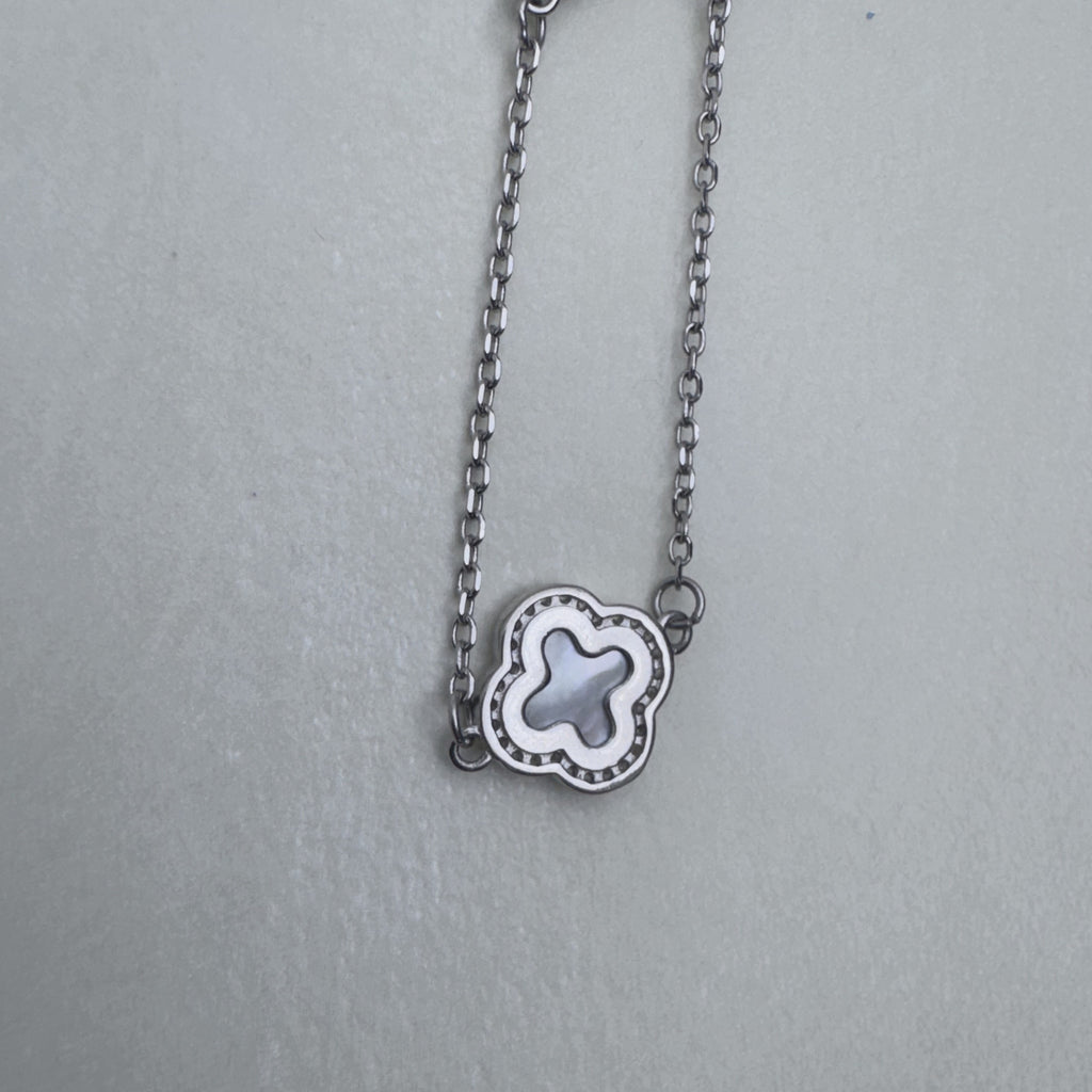 A single mother of pearl clover station on the silver cable chain.