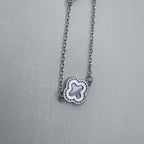 A single mother of pearl clover station on the silver cable chain.