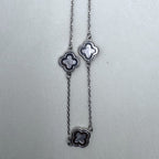 Three clover stations along the cable chain of the necklace.