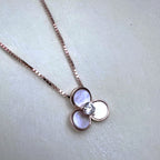 Rose-tone sterling silver pendant necklace with three mother of pearl petals and an American Diamond centre, on a box chain.
