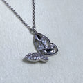 Sterling silver butterfly pendant necklace with one pave set wing and one open marquise wing, on a cable chain.