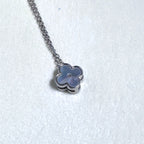 Sterling silver necklace with a small grey mother of pearl clover on a fine rolo chain.