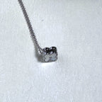 The clover turned to show its other face on the silver chain.
